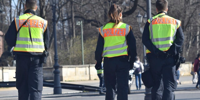 Police guard during the half marathon run in Berlin, Sunday, April 8, 2018.
