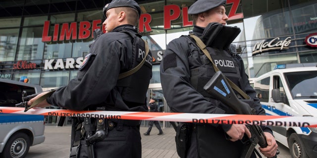 Police guard in front of a shopping mall in Essen, Germany, Saturday, March 11, 2017.