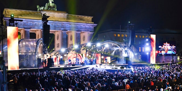 In this Dec. 31, 2016 file photo numerous visitors stand in front of the stage at the Brandenburg Gate where the New Year's Eve party is taking place in Berlin, Germany.