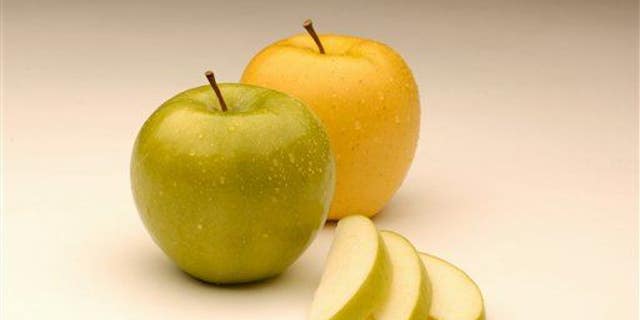 An Arctic Granny apple, left, from Canada's Okanagan Specialty Fruits is seen with an Arctic Golden variety, right.