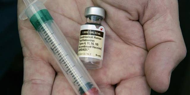In this Aug. 28, 2006 file photo, a doctor holds a vial of the human papillomavirus (HPV) vaccine Gardasil in his Chicago office.