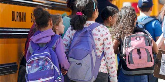Kids get ready to board the school bus.