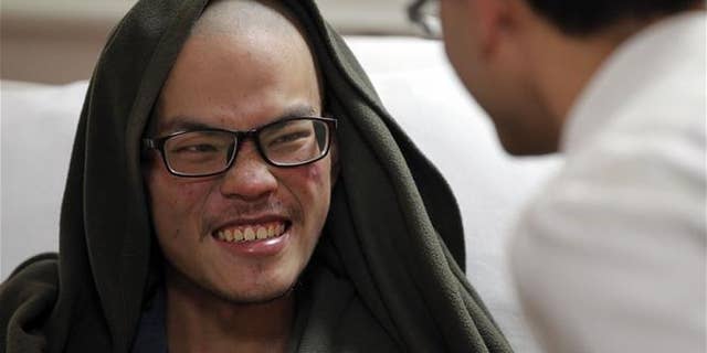 Taiwanese man Liang Sheng-yueh talks to a doctor at the Grande Hospital in Kathmandu, Nepal, Wednesday, April 26, 2017.