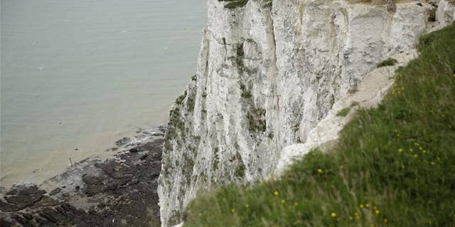 Visitors look down from the top of a section of the White Cliffs of Dover on June 9, 2016.