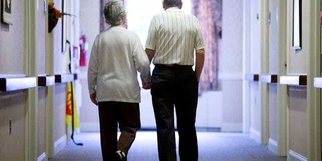In this Nov. 6, 2015 file photo, an elderly couple walks down a hall in Easton, Pa. It's not too late to get moving: Simple physical activity, mostly walking, helped high-risk seniors stay mobile after disability-inducing ailments even if, at 70 and beyond, they'd long been couch potatoes.