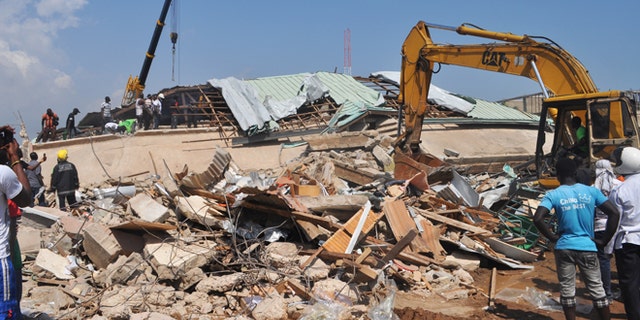 Nov. 7, 2012: Rescue workers toil among the remainder of a collapsed building in Accra, Ghana.