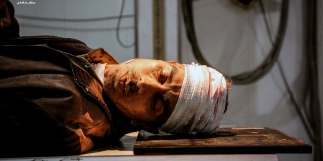 An injured man waits for treatment at a hospital in Ghouta, a suburb of Damascus.