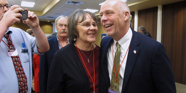 FILE - In this March 6, 2017, file photo, Greg Gianforte, right, receives congratulations from a supporter in Helena, Mont. Montana voters are heading to the polls Thursday, May 25, 2017, to decide a nationally watched congressional election amid uncertainty in Washington over President Donald Trump's agenda and his handling of the country's affairs. (AP Photo/Matt Volz, File)