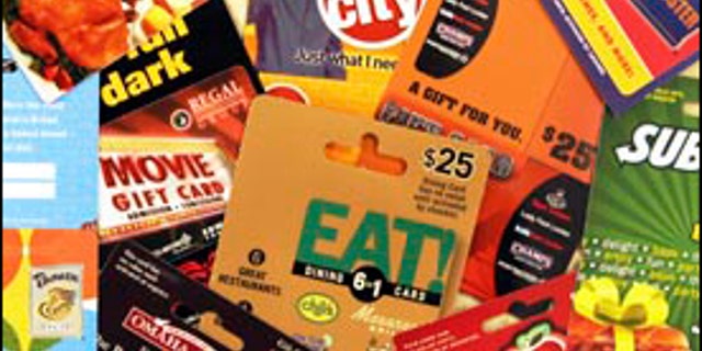 ** FILE ** A variety of gift cards for use at various stores and restaurants are seen at a convenience store in Brunswick, Maine, in this Dec. 12, 2007 file photo. The state of Maine wants its share of gift cards that go unused, and State Treasurer David Lemoine is asking the attorney general to look into what the state can do to enforce the new law. So far, out-of-state retailers have either refused to pay or have challenged the legality of the law. (AP Photo/Pat Wellenbach, file)