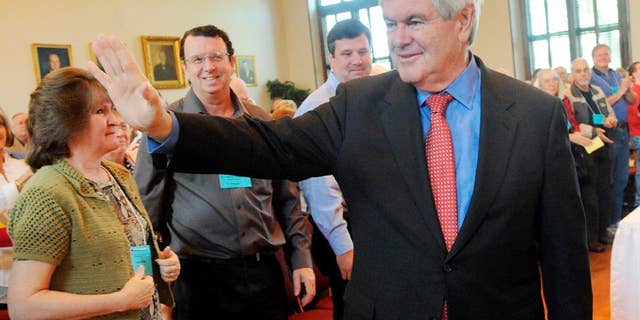 Former Speaker of the House Newt Gingrich is greeted to a standing ovation as he walks into the Historic Courthouse, Saturday, April 16, 2011, in Lawrenceville, Ga. Gingrich spoke during the GOP district convention at the courthouse. (AP Photo/Gwinnett Daily Post, Jonathan Phillips)