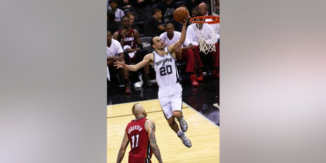 SAN ANTONIO, TX - JUNE 5: Manu Ginobili #20 of the San Antonio Spurs shoots a layup over Chris Andersen #11 of the Miami Heat in Game One of the 2014 NBA Finals.