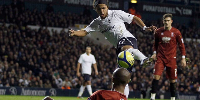 Tottenham Hotspur's Giovani Dos Santos, top, vies for the ball with Cheltenham Town's Sido Jombati during the English FA Cup third round soccer match at White Hart Lane Stadium in London, Saturday Jan. 7, 2012. (AP Photo/Kirsty Wigglesworth)