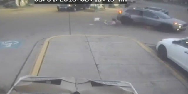A young girl jumps out of a moving SUV during a carjacking at a Chicago-area gas station on Friday.