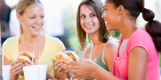 girls having lunch at school istock