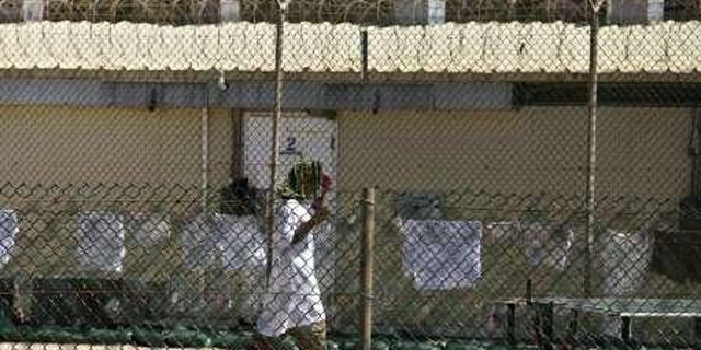 A detainee walks inside a yard at the detention facility at Guantanamo Bay May 31, 2010.