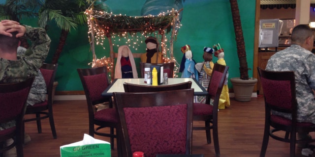 Dec, 18, 2013: Troops eat lunch near a nativity scene at the Guantanamo Bay naval base.