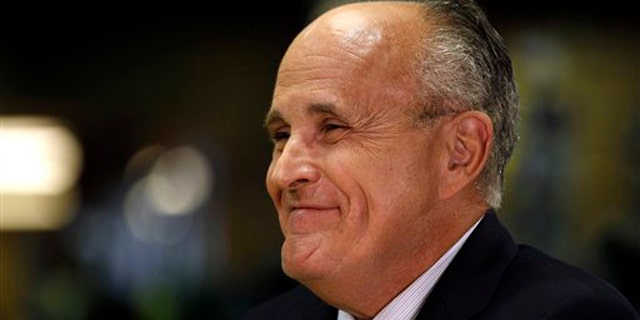 Former New York City Mayor Rudy Giuliani smiles during a visit to the Manchester Harley Davidson store in Manchester, N.H., July 14.
