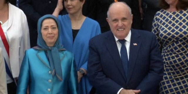 Rudy Giuliani poses for a photo with Maryam Rajavi, the leader of the National Council of Resistance of Iran, at a rally in Villepinte, France Saturday.