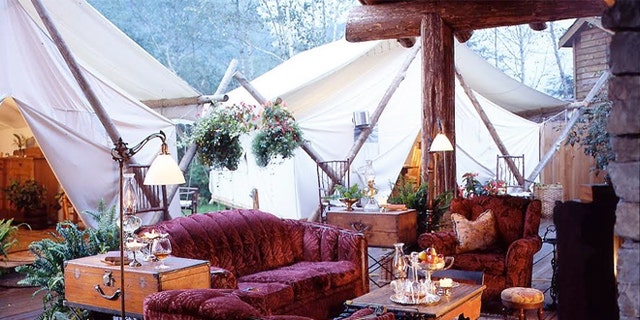 The tent lounge area at Clayouquot Resort in Vancouver Island, Canada has comfy couches and amenities you'd find at home.