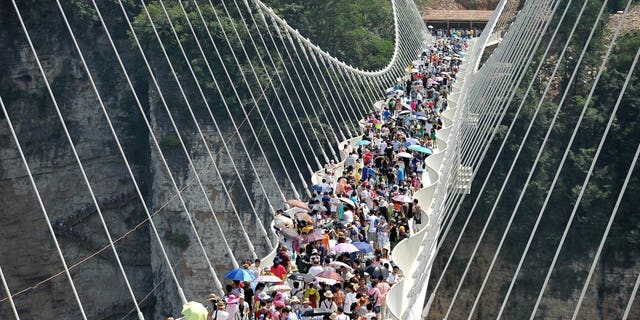 Hundreds flock to the opening of the world's tallest, highest glass bottom bridge in Zhangjiajie, Hunan Province, China, August 20, 2016.