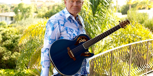 In this July 27, 2011 photo, musician Glen Campbell poses for a portrait in Malibu, Calif. Campbell, the grinning, high-pitched entertainer who had such hits as "Rhinestone Cowboy" and spanned country, pop, television and movies, died Tuesday, Aug. 8, 2017. He was 81. Campbell announced in June 2011 that he had been diagnosed with Alzheimer's disease. (AP Photo/Matt Sayles, File)