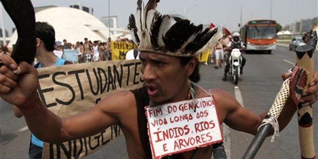 An Indian wearing a traditional headdress at a protest in Brasilia, Brazil, by various Indian communities in defense of the Guarani-Kaiowa tribe who are involved in a land dispute.