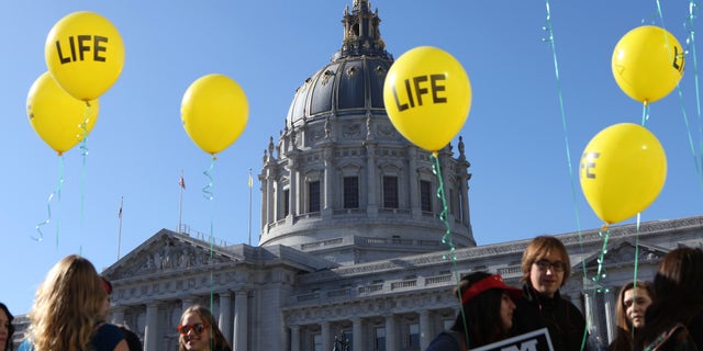 Members of the St. Rose of Lima Parish of Paso Robles Calif. arrive to the "Walk for Life" rally and march in San Francisco on Saturday, Jan. 24, 2015. Thousands of abortion opponents gathered at Civic Center Plaza in front of City Hall for the 11th annual event before marching down Market Street to Justin Herman Plaza. (AP Photo/Alex Washburn)