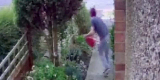 CCTV footage shows the man sneaking along a path at the side of a house before he reappears moments later carrying the garden ornament.