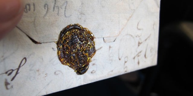 The Brienne trunk contained hundreds of unopened letters. Thie one features a gold wax seal.