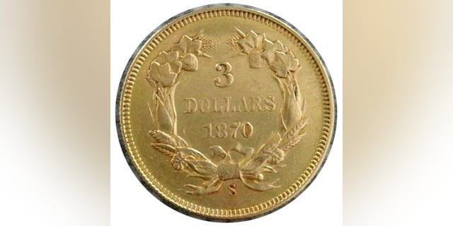 The coin, seen here, is believed to be a 1870-S $3 piece from the San Francisco Mint that was found embedded into a souvenir book, according to Steve White, owner of the Four Seasons Auction Gallery. (Courtesy: Four Seasons Auction Gallery)