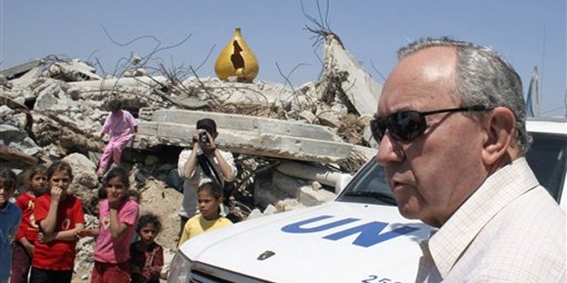 FILE: In this June 3, 2009, photo, U.N. investigator Richard Goldstone visits a house destroyed during an artillery strike during Israel's offensive in January 2009 in Gaza City.