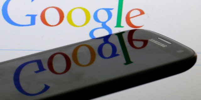 A Google logo is reflected on the screen of a Samsung Galaxy S4 smartphone in this photo illustration taken in Prague January 31, 2014. Google Inc and Samsung Electronics Co Ltd, which are frequently involved in patent infringement lawsuits but not against each other, announced on January 26, 2014 that they have reached a global patent cross-licensing agreement. Picture taken January 31. REUTERS/David W Cerny (CZECH REPUBLIC - Tags: BUSINESS TELECOMS SCIENCE TECHNOLOGY LOGO)
