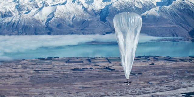 June 10, 2013: A Google balloon sails through the air with the Southern Alps mountains in the background, in Tekapo, New Zealand.