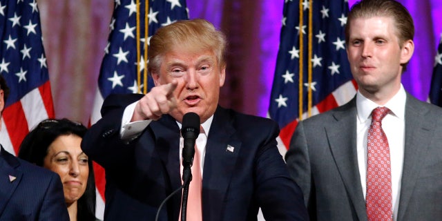 Republican presidential candidate Donald Trump speaks to supporters at his primary election night event at his Mar-a-Lago Club in Palm Beach, Fla., Tuesday, March 15, 2016. at right is his son Eric Trump (AP Photo/Gerald Herbert)