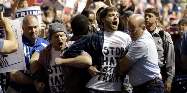 Protesters are removed from a Donald Trump rally in Fayetteville, N.C.