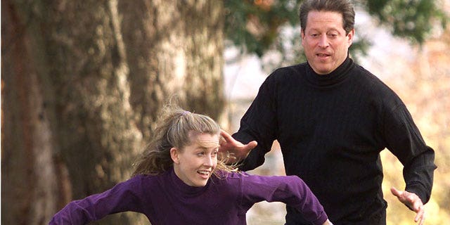 Vice President Al Gore covers his daughter Karenna on a pass play during a touch football game with his family, November 10, 2000 outside the Vice Presidential residence in Washington. (Reuters)