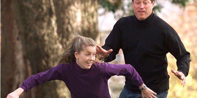 Vice President Al Gore covers his daughter Karenna on a pass play during a touch football game with his family, November 10, 2000 outside the Vice Presidential residence in Washington. (Reuters)