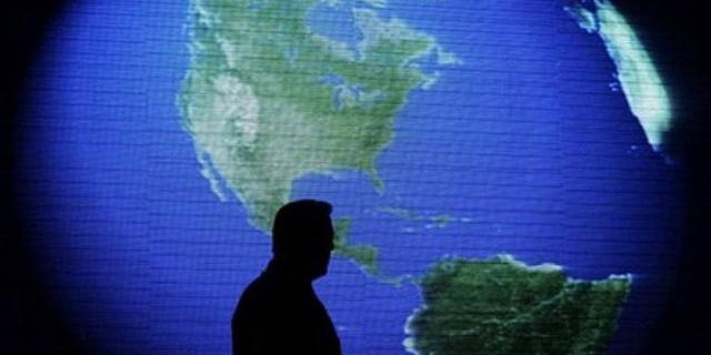 FILE: Former U.S. Vice President and environmentalist Al Gore is silhouetted against an image of the earth during his June 8 talk about climate change in Manila, Philippines. Gore said at a green energy business conference in Athens that lobbyists have wrongly kept alive the ethanol program he once touted.
