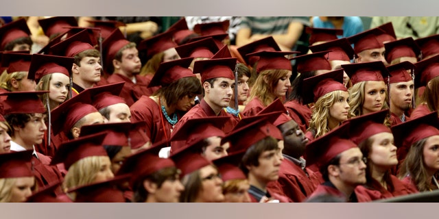 Members of the class of 2012 listen as President Barack Obama delivers the commencement address for Joplin High School Monday, May 21, 2012, in Joplin, Mo. Seniors at the school finished their high school education in a converted big-box store after the old high school was destroyed by an EF-5 tornado that killed 161 people on graduation day a year ago. (AP Photo/Charlie Riedel)