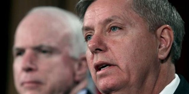 FILE: Feb. 2, 2012: Sen. Lindsey Graham, right, and Sen. John McCain are shown speaking to reporters on Capitol Hill in Washington.