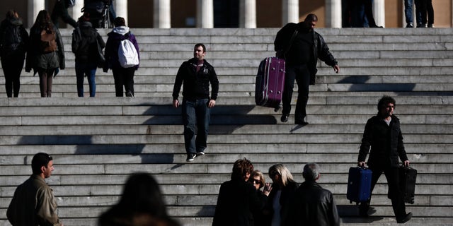 Jan. 9 ,2015: Pedestrians walk in front of the Greek parliament, in central Athens.
