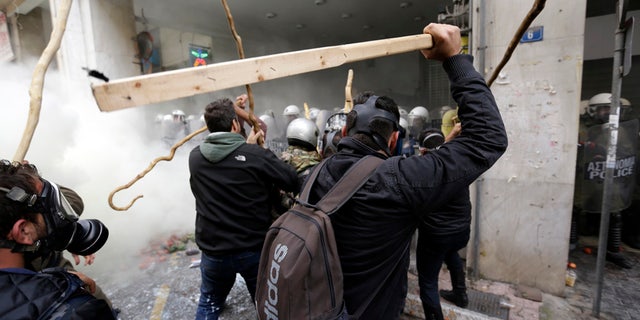 Feb. 12, 2016: Farmers clash with riot police during a protest outside Agriculture ministry in Athens.