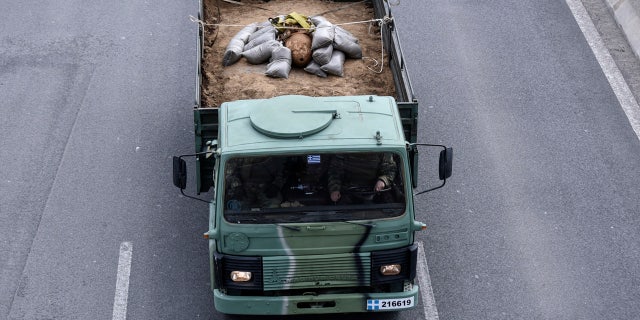 A military truck carries an unexploded World War II bomb which was defused by Greek Army personnel in Thessaloniki, Greece Sunday, Feb. 12, 2017.