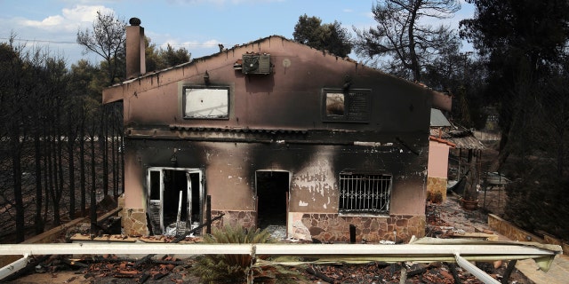 A burned house is seen in Agios Andreas, east of Athens.