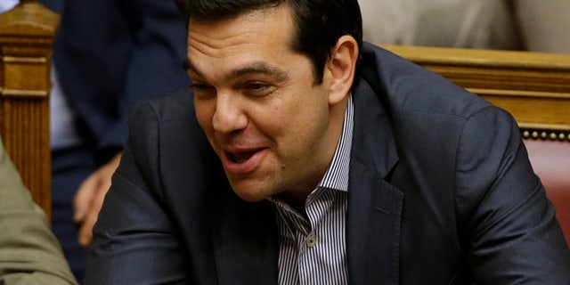 July 11, 2015: Greece's Prime Minister Alexis Tsipras laughs during a parliament meeting in Athens. (AP)