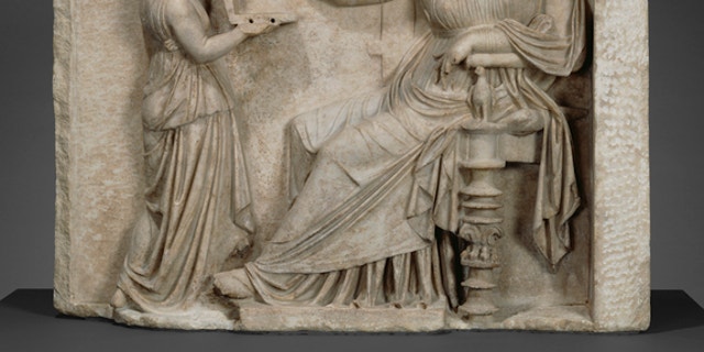 Is this ancient Greek woman checking Facebook on her so-called laptop?