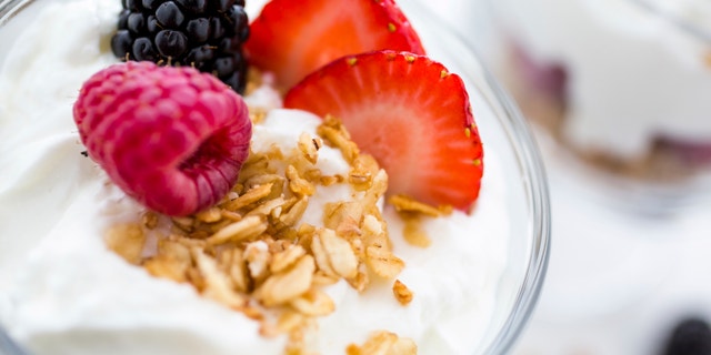 A breakfast parfait is made from Greek yogurt and granola topped with fresh berries. It can be prepped the night before and popped into the fridge.