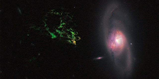 In this image by NASA's Hubble Space Telescope, an unusual, ghostly green blob of gas appears to float near a normal-looking spiral galaxy. The bizarre object, dubbed Hanny's Voorwerp (Hanny's Object in Dutch), is the only visible part of a 300,000-light-year-long streamer of gas stretching around the galaxy, called IC 2497.
