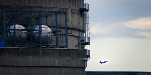 In this photo released by Greenpeace, a drone resembling the character of Superman flies over the nuclear power plant of Le Bugey, central, France, Tuesday, July 3, 2018.