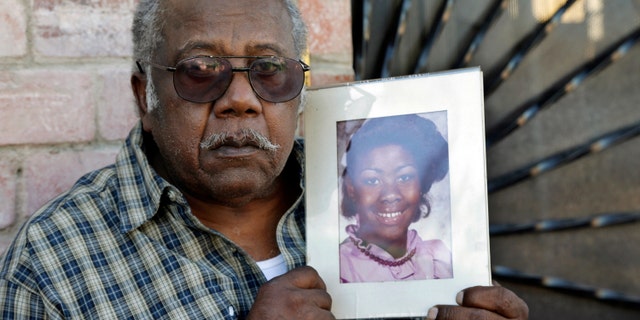Porter Alexander holds a photo of his daughter, an alleged victim of the "Grim Sleeper" serial killer.